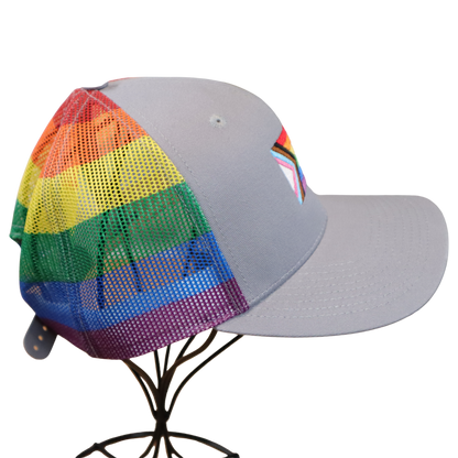 Back of a gray hat with rainbow striped mesh panels, displayed on a wire hat stand
